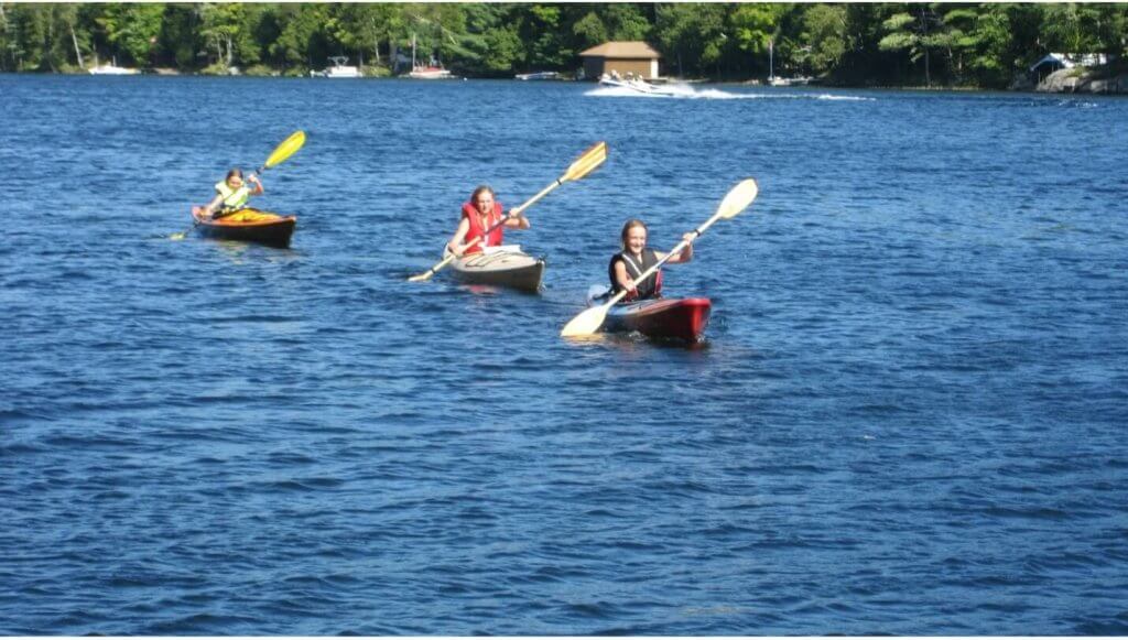three kayaks on a breezy lake